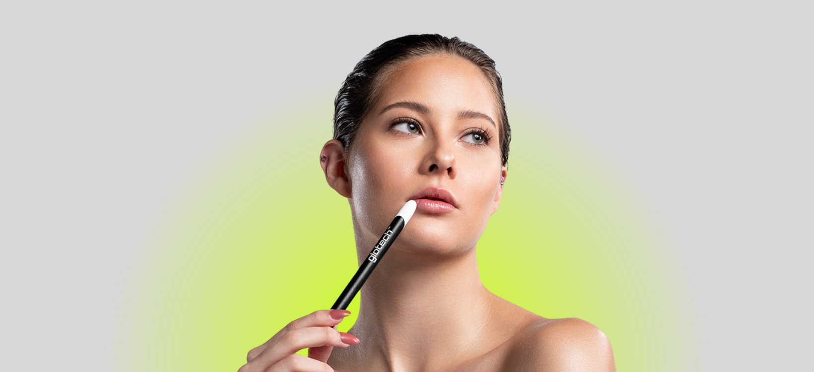 Model holding Glotech™ LED esthetics lip wand, innovative skincare tool for cold sore treatment and lip rejuvenation