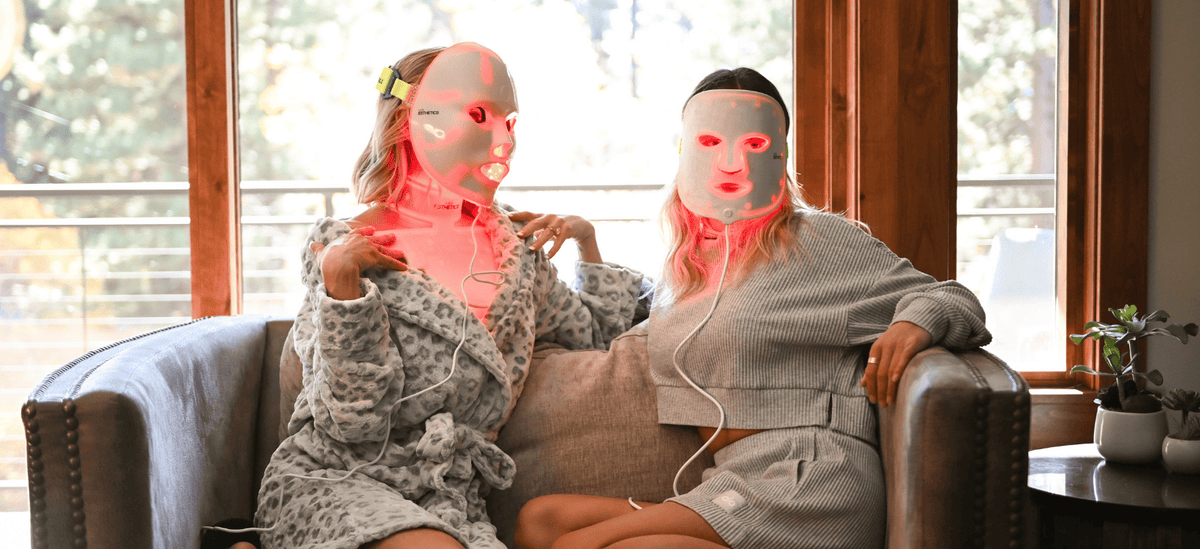 Two women wearing LED Esthetics red light therapy face masks at home, demonstrating post-microneedling recovery and collagen-supporting red light therapy for skin healing.