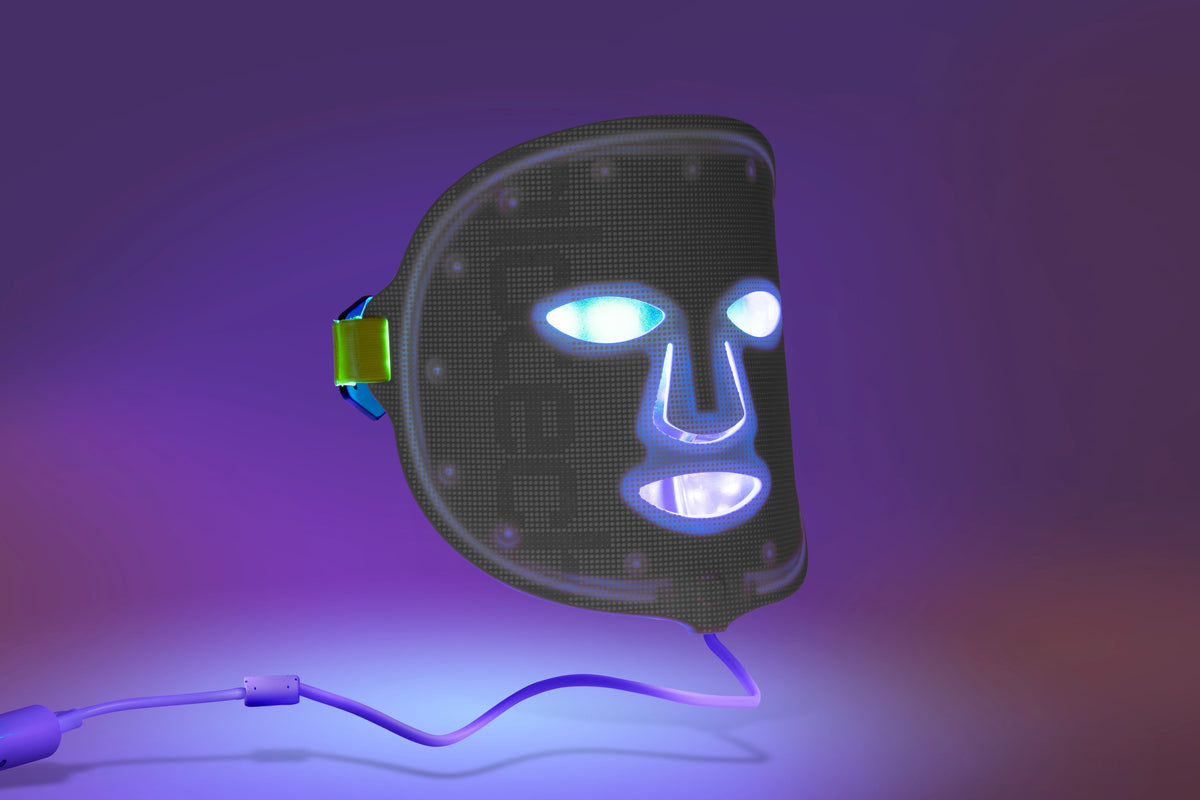 LED face mask for blue light therapy, featuring illuminated eye, nose, and mouth areas, grid-textured surface, adjustable strap, and glowing blue LEDs for skincare benefits.