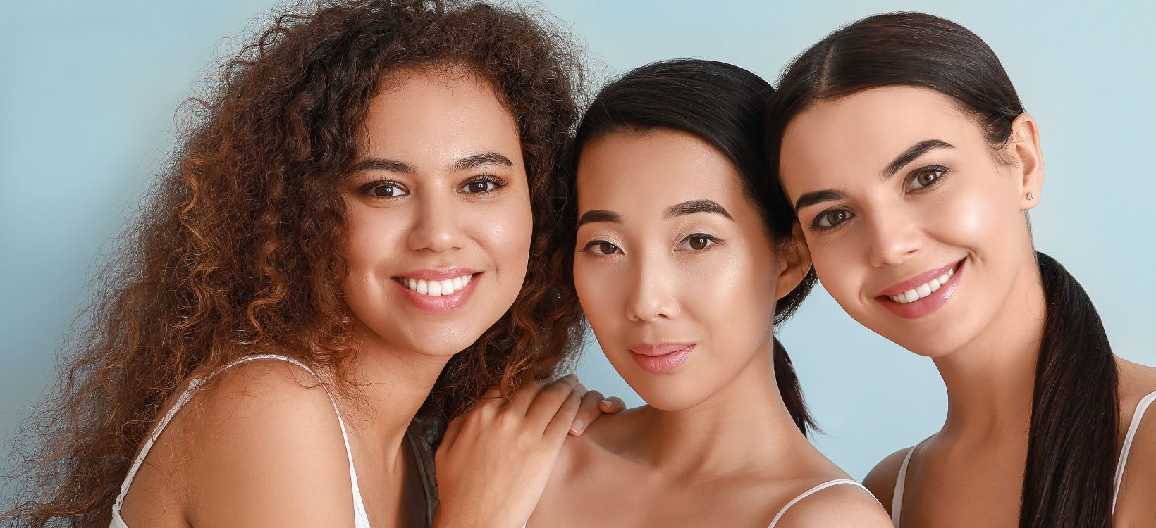 Three women with glowing skin benefiting from LED light therapy