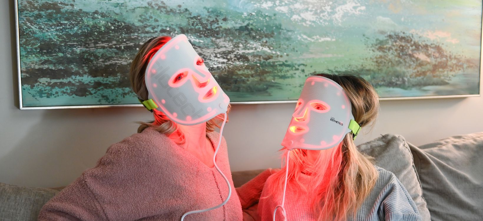 Women using LED light therapy masks for skincare treatment, red light facial therapy, beauty and wellness routine at home