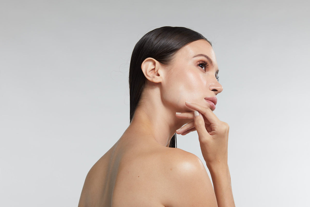 Topless woman feeling sensual with glowing skin